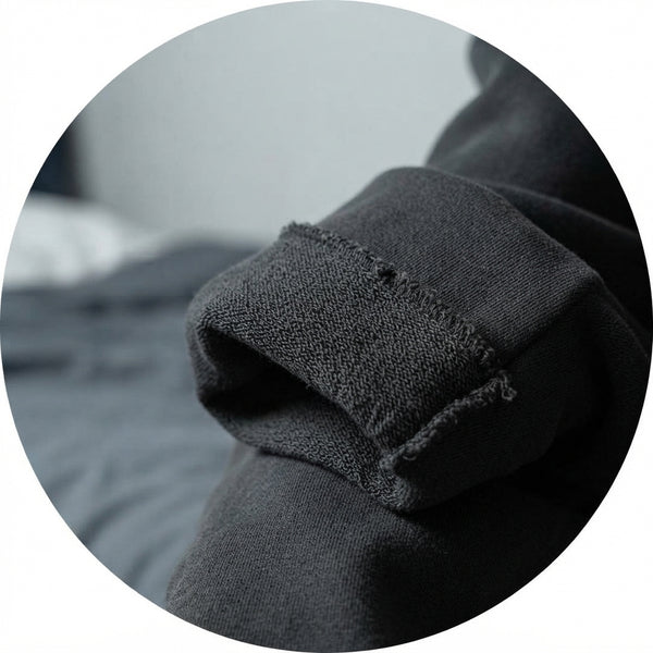 Close-up of high-quality charcoal gray heavy French Terry fabric showing detailed texture and structural weave.